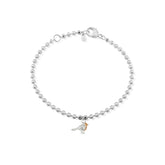 A sterling silver bracelet with small beads, featuring a rose gold beaded chain and a small charm of a robin breast, presented against a white background.